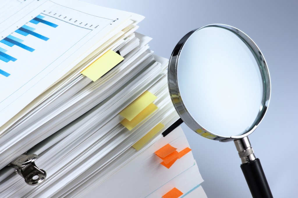 Magnifying glass showing editing of business documents